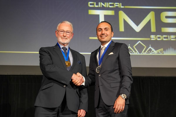 Dr Abdelghani awarding Prof Anthony Barker the CTMSS Medal of Honour