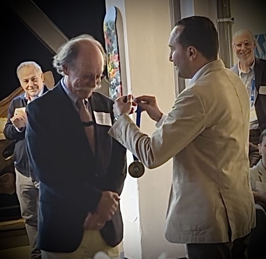 Dr Mohamed Abdelghani presenting Prof Mark George with the CTMSS Medal of Honor